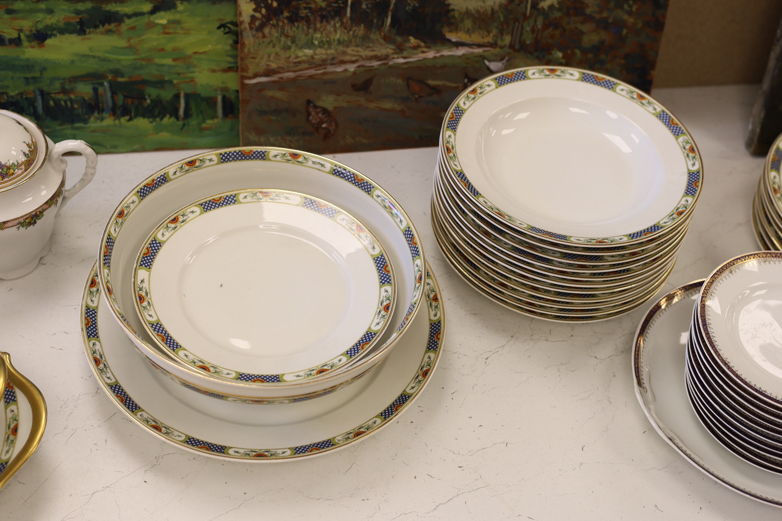 A Limoges gilt and floral decorated dinner service